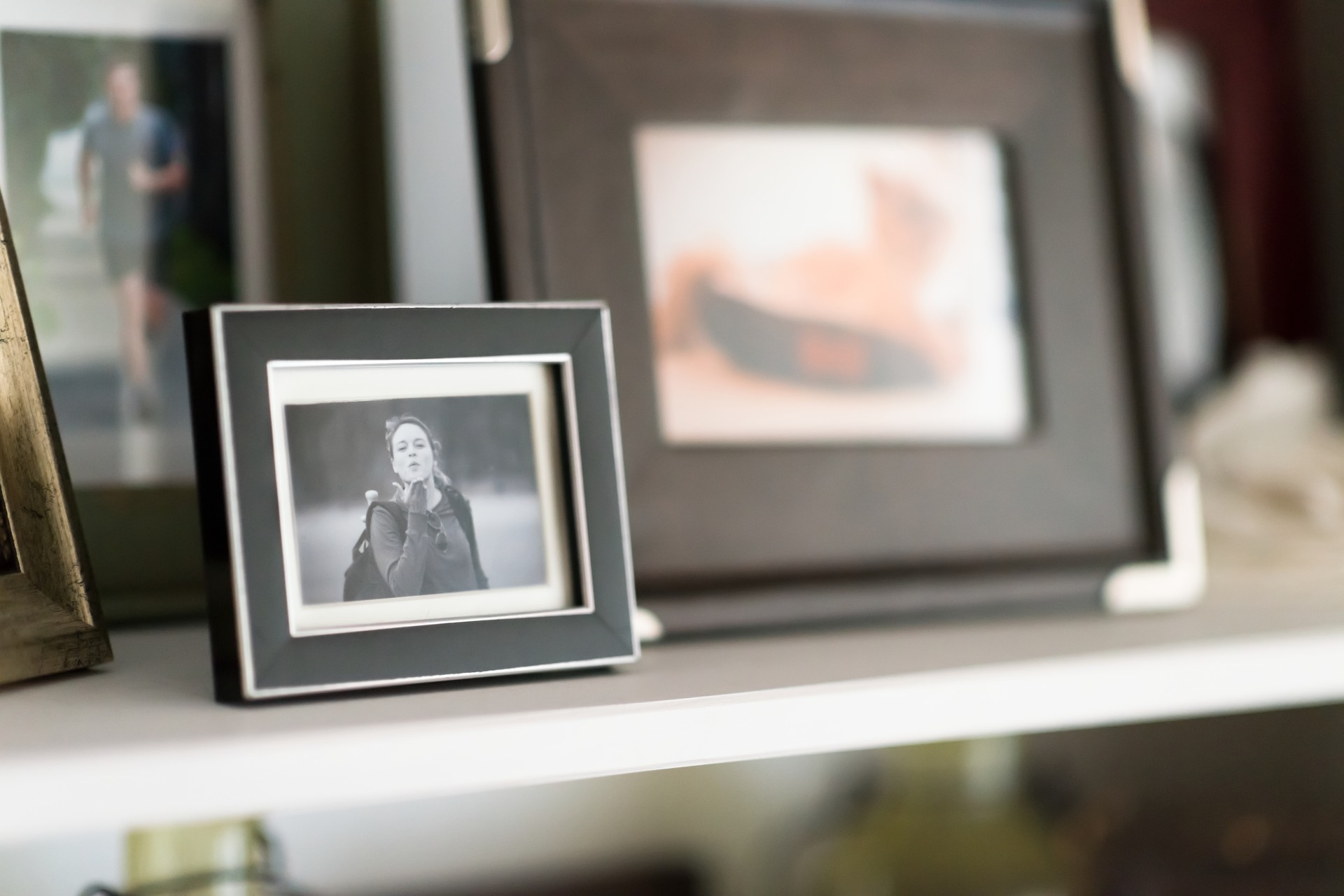 Family Snapshots Framed on Shelf